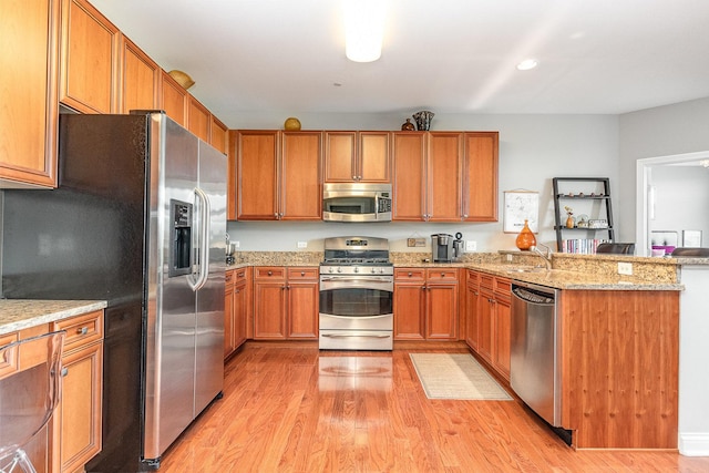 140 S River St Unit 307, Aurora, IL 60506 - kitchen with appliances with stainless steel finishes, a peninsula, light wood-style flooring, light stone countertops, and recessed lighting