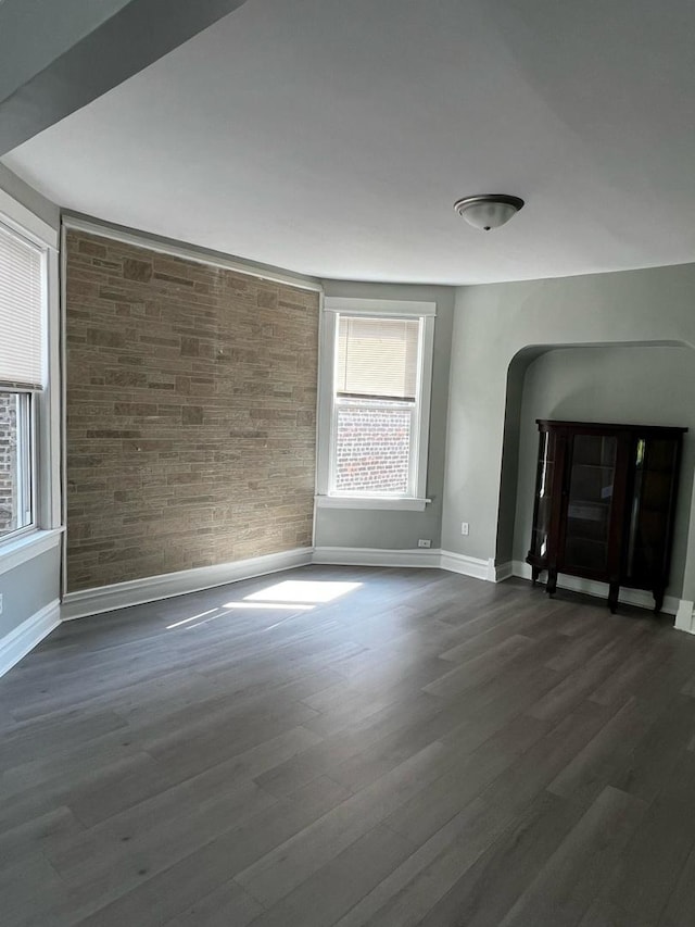 730 N Spaulding Ave, Chicago, IL 60624 - unfurnished living room with baseboards and dark wood-type flooring