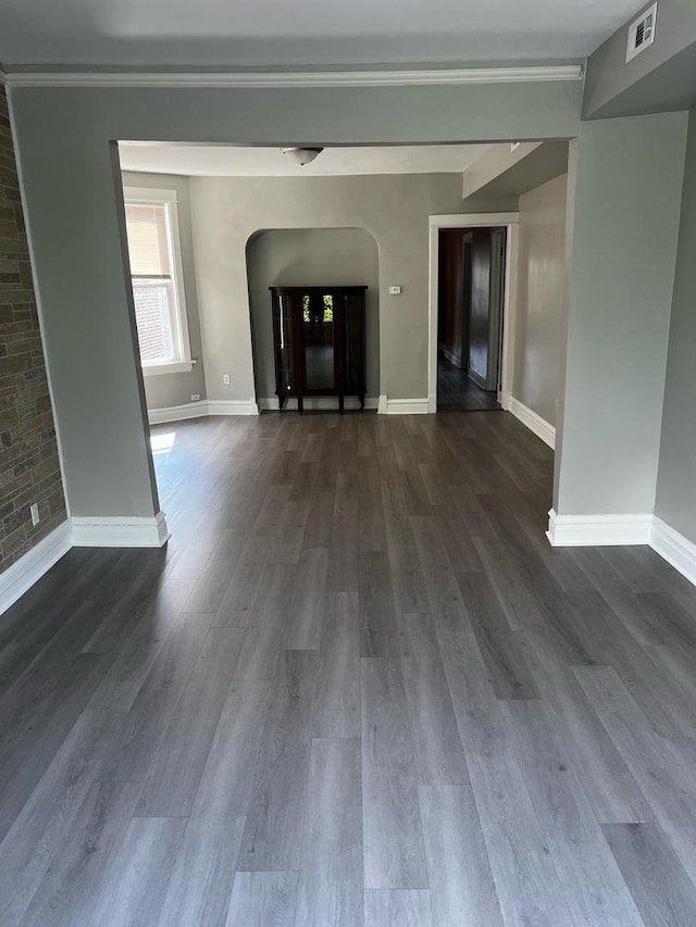 730 N Spaulding Ave, Chicago, IL 60624 - unfurnished living room with dark wood-style flooring and arched walkways