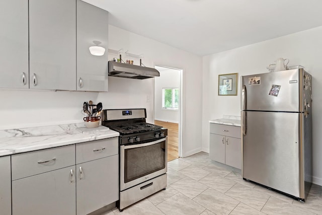 321 Newman Ct, Lake Bluff, IL 60044 - kitchen with appliances with stainless steel finishes, under cabinet range hood, gray cabinets, light marble finish flooring, and light stone countertops