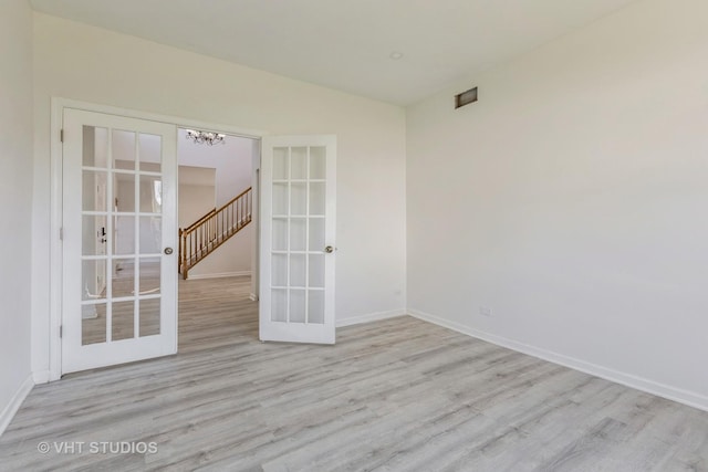2895 Lahinch Ct, Aurora, IL 60503 - empty room with french doors, wood finished floors, and a chandelier