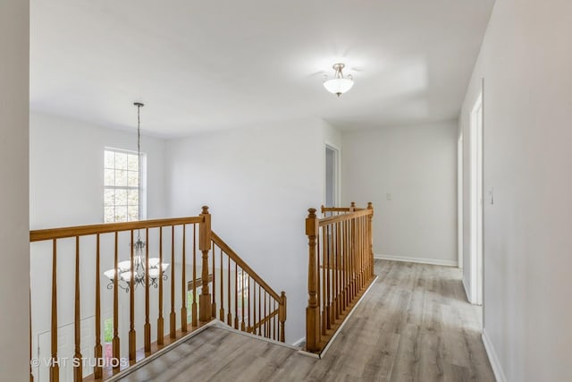 2895 Lahinch Ct, Aurora, IL 60503 - corridor featuring an upstairs landing, wood finished floors, and a chandelier