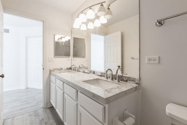 2895 Lahinch Ct, Aurora, IL 60503 - bathroom featuring double vanity, wood finished floors, and a chandelier