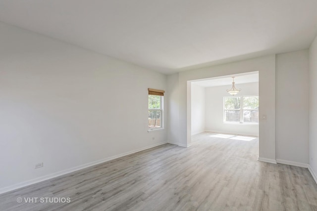 2895 Lahinch Ct, Aurora, IL 60503 - spare room featuring light wood-style floors and a chandelier