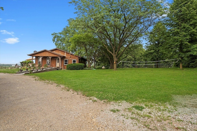 16383 US Highway 52, Newark, IL 60541 - view of grassy yard featuring volleyball court, dirt driveway, and covered porch
