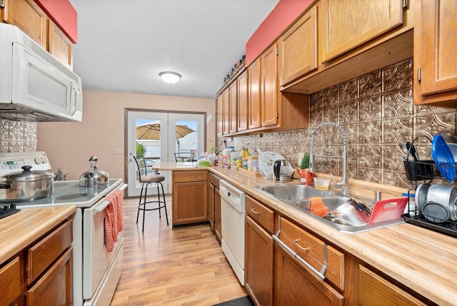 16383 US Highway 52, Newark, IL 60541 - kitchen featuring white appliances, a peninsula, light wood-style flooring, decorative backsplash, and butcher block countertops