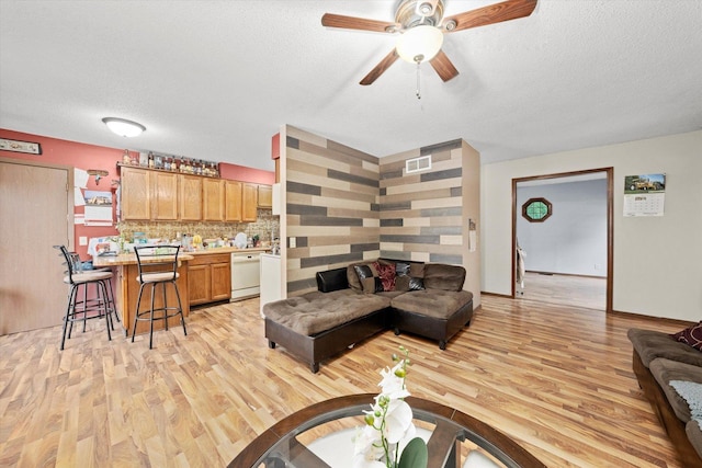 16383 US Highway 52, Newark, IL 60541 - living room featuring light wood-style floors, a textured ceiling, and ceiling fan