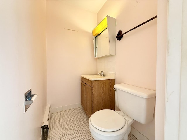 8928 Stevens Dr Unit 1A, Des Plaines, IL 60016 - half bath featuring a baseboard heating unit, vanity, and tile patterned floors