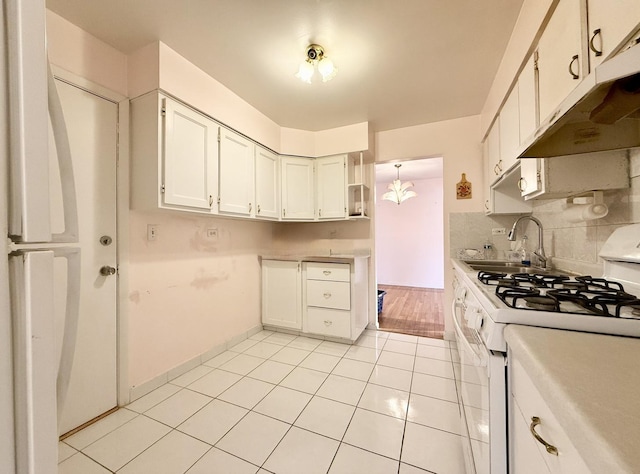 8928 Stevens Dr Unit 1A, Des Plaines, IL 60016 - kitchen with white gas range oven, under cabinet range hood, light tile patterned floors, light countertops, and decorative backsplash