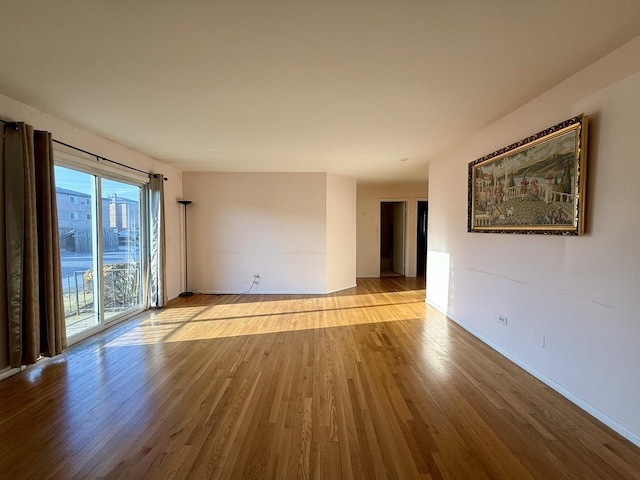 8928 Stevens Dr Unit 1A, Des Plaines, IL 60016 - empty room with wood finished floors and baseboards