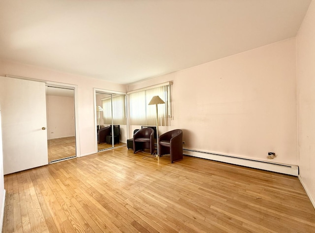 8928 Stevens Dr Unit 1A, Des Plaines, IL 60016 - living area with baseboard heating and wood-type flooring