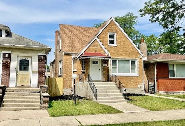 9302 S Eberhart Ave, Chicago, IL 60619 - view of front of property with brick siding and a chimney