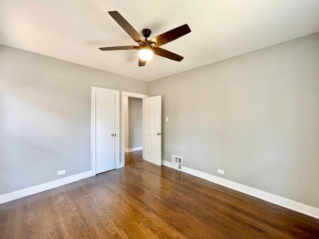 9302 S Eberhart Ave, Chicago, IL 60619 - unfurnished bedroom featuring dark wood-type flooring and a ceiling fan