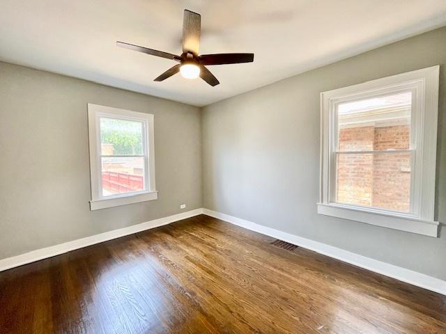 9302 S Eberhart Ave, Chicago, IL 60619 - unfurnished room featuring dark wood finished floors and a ceiling fan
