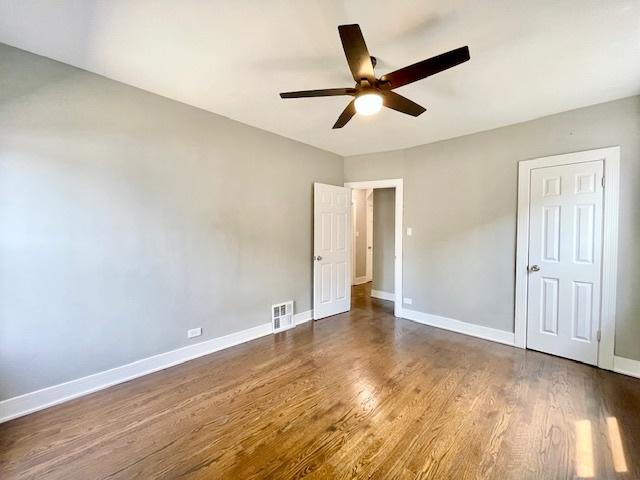 9302 S Eberhart Ave, Chicago, IL 60619 - unfurnished bedroom with wood finished floors and ceiling fan