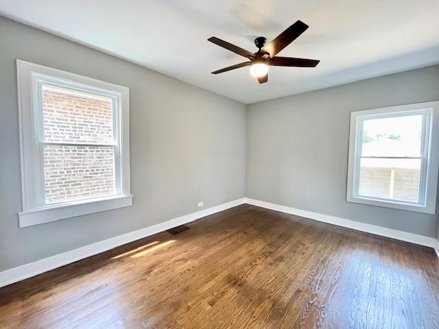 9302 S Eberhart Ave, Chicago, IL 60619 - empty room with dark wood finished floors and a ceiling fan