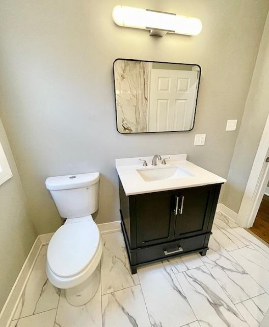 9302 S Eberhart Ave, Chicago, IL 60619 - bathroom with vanity and marble look tiles
