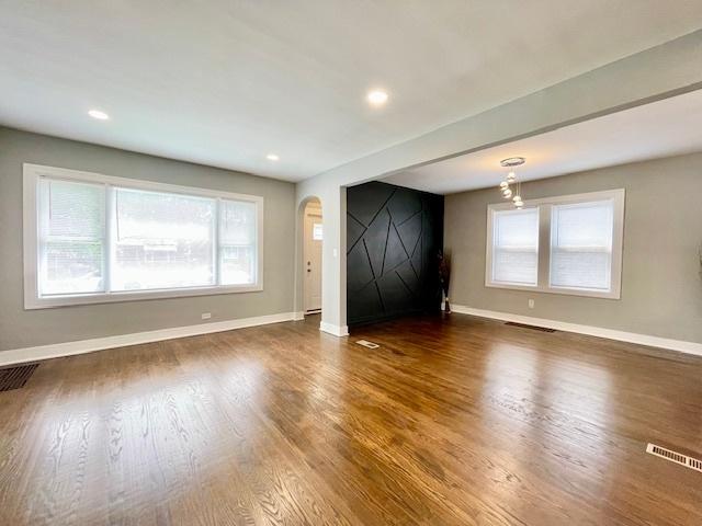 9302 S Eberhart Ave, Chicago, IL 60619 - unfurnished living room with arched walkways, dark wood finished floors, and recessed lighting