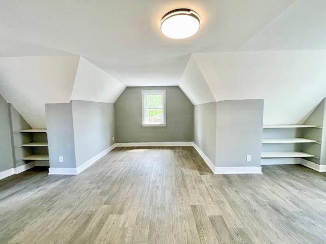 9302 S Eberhart Ave, Chicago, IL 60619 - additional living space with built in features, lofted ceiling, and wood finished floors