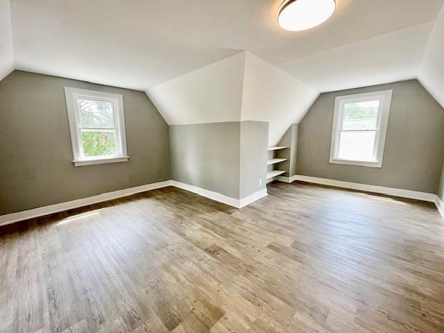 9302 S Eberhart Ave, Chicago, IL 60619 - additional living space with healthy amount of natural light, vaulted ceiling, and wood finished floors