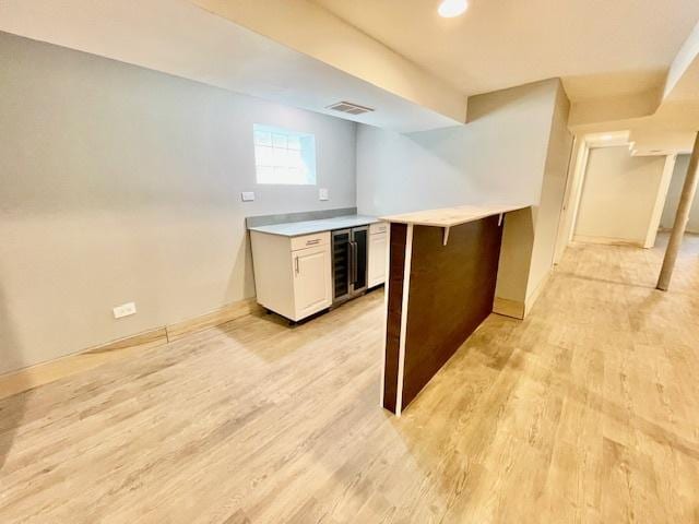 9302 S Eberhart Ave, Chicago, IL 60619 - kitchen featuring beverage cooler, light wood-style floors, a peninsula, and light countertops