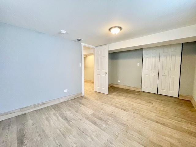 9302 S Eberhart Ave, Chicago, IL 60619 - unfurnished bedroom with light wood finished floors and a closet