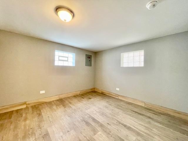 9302 S Eberhart Ave, Chicago, IL 60619 - basement featuring electric panel and wood finished floors