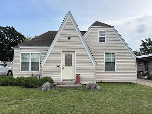 2715 W Ridgeland Ave, Waukegan, IL 60085 - view of front facade with a front lawn and a shingled roof