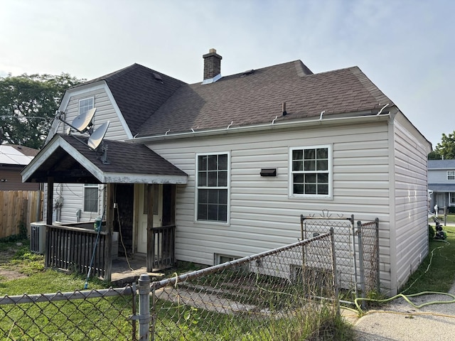 2715 W Ridgeland Ave, Waukegan, IL 60085 - back of house with a shingled roof and a chimney