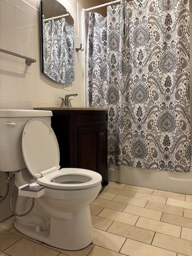 2715 W Ridgeland Ave, Waukegan, IL 60085 - full bathroom featuring tile walls, vanity, tile patterned floors, and shower / bath combo with shower curtain