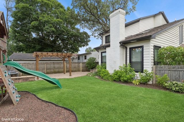 1315 Ardmore Dr, Round Lake Beach, IL 60073 - fenced backyard with a playground and a pergola