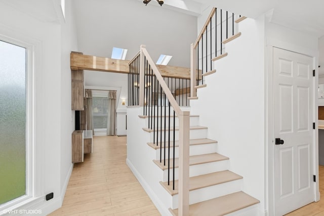 1315 Ardmore Dr, Round Lake Beach, IL 60073 - stairs featuring wood finished floors and a skylight