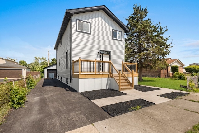 15355 7th Ave, Phoenix, IL 60426 - view of front facade with a detached garage, a wooden deck, and an outdoor structure