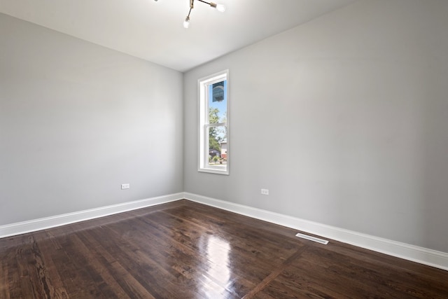 15355 7th Ave, Phoenix, IL 60426 - spare room featuring dark wood-style floors and baseboards