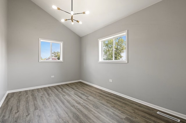 15355 7th Ave, Phoenix, IL 60426 - empty room with a chandelier, plenty of natural light, wood finished floors, and vaulted ceiling