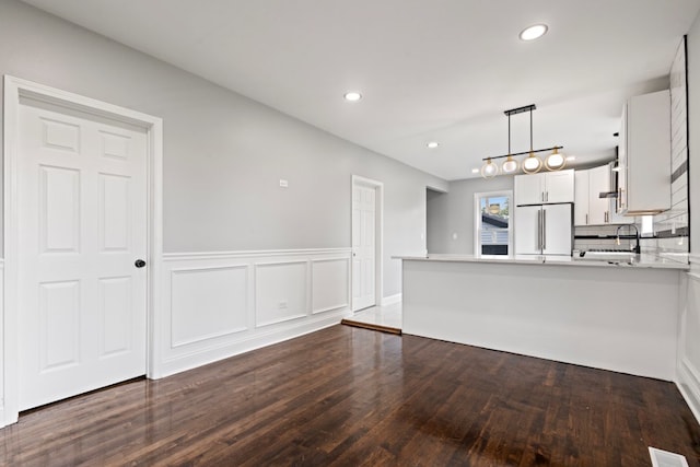 15355 7th Ave, Phoenix, IL 60426 - kitchen featuring freestanding refrigerator, white cabinetry, a peninsula, light countertops, and dark wood-style flooring