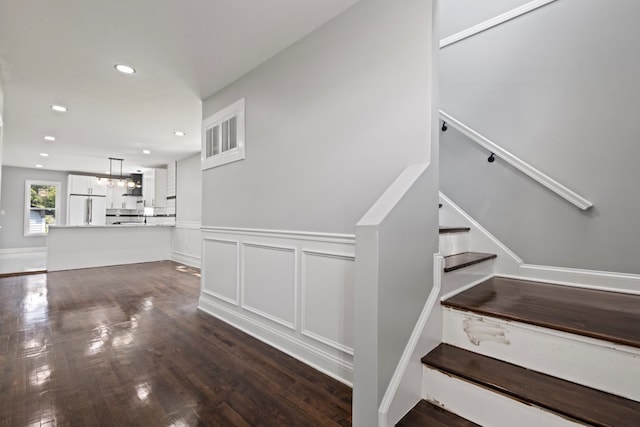 15355 7th Ave, Phoenix, IL 60426 - stairs with recessed lighting, wood finished floors, wainscoting, and a chandelier