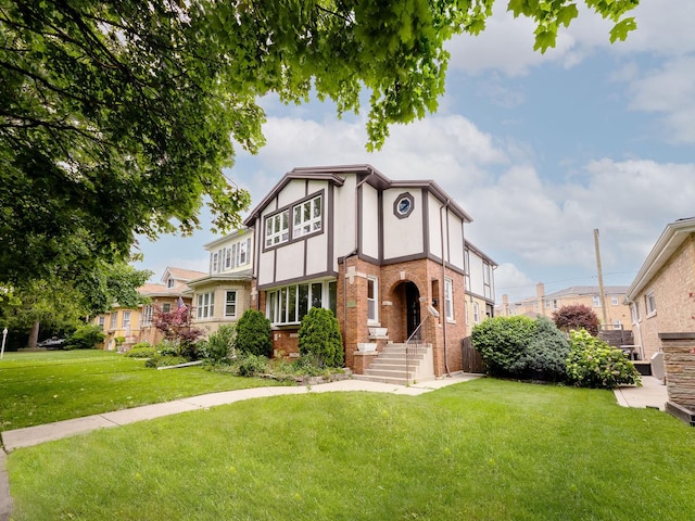 6527 N Onarga Ave, Chicago, IL 60631 - tudor-style house with a front yard, stucco siding, and brick siding
