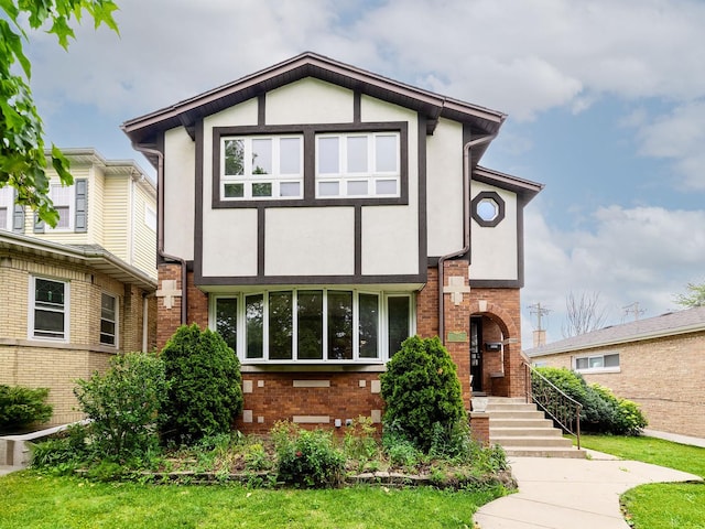 6527 N Onarga Ave, Chicago, IL 60631 - tudor-style house featuring stucco siding and brick siding