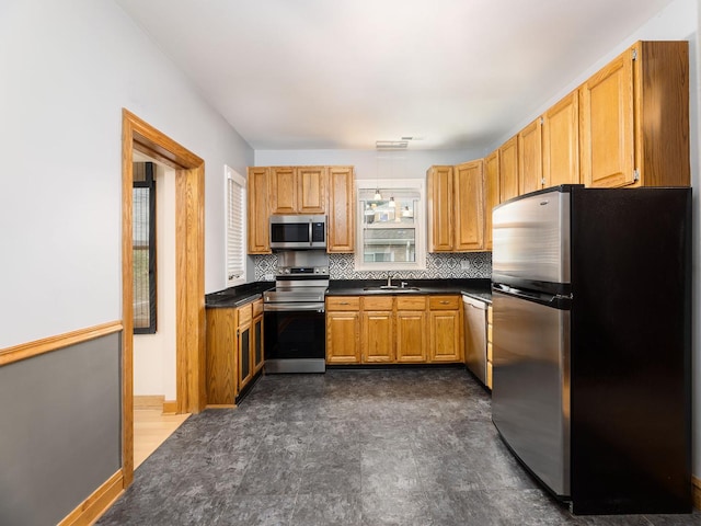 6527 N Onarga Ave, Chicago, IL 60631 - kitchen featuring stainless steel appliances, dark countertops, tasteful backsplash, and brown cabinetry