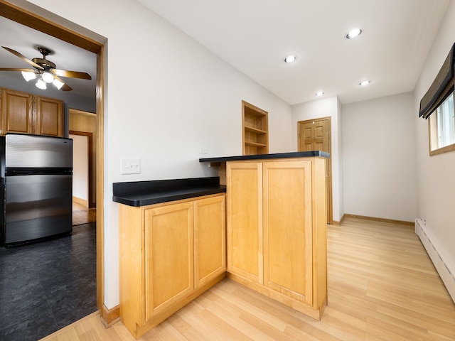 6527 N Onarga Ave, Chicago, IL 60631 - kitchen featuring freestanding refrigerator, dark countertops, a baseboard radiator, light wood finished floors, and ceiling fan