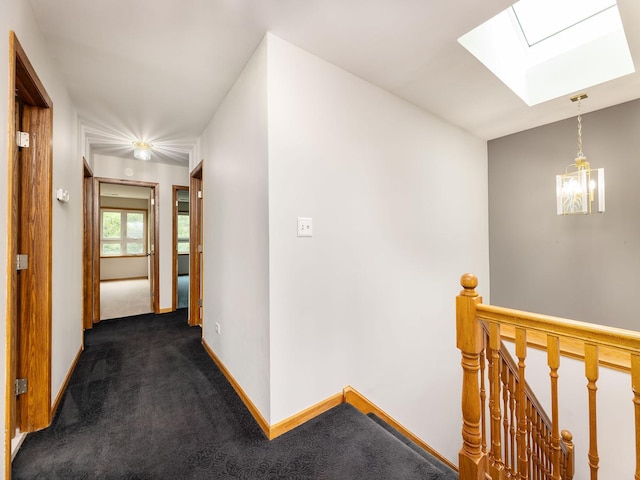 6527 N Onarga Ave, Chicago, IL 60631 - hallway with a skylight, an upstairs landing, dark colored carpet, and a chandelier