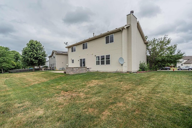 3505 Indian Head Ln, Joliet, IL 60435 - rear view of house featuring a chimney and a lawn