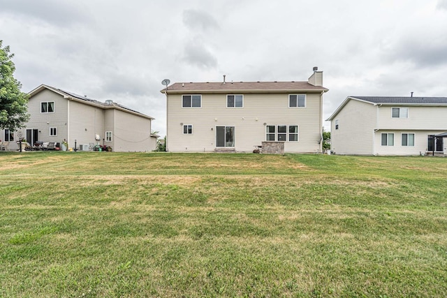 3505 Indian Head Ln, Joliet, IL 60435 - back of property featuring a chimney and a lawn