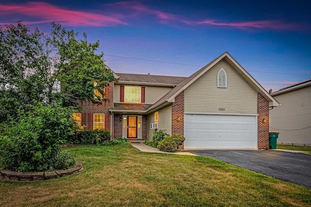3505 Indian Head Ln, Joliet, IL 60435 - traditional home featuring asphalt driveway, brick siding, an attached garage, and a lawn