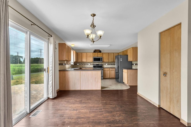 3505 Indian Head Ln, Joliet, IL 60435 - kitchen featuring appliances with stainless steel finishes, wood finished floors, tasteful backsplash, a chandelier, and a peninsula