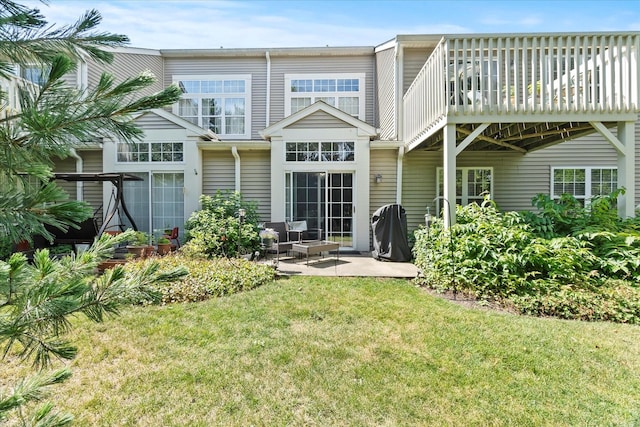 2204 Waterleaf Ct Unit 103, Naperville, IL 60564 - rear view of house featuring a yard, a patio area, and a wooden deck