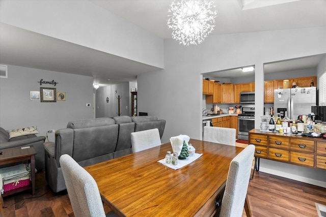 2204 Waterleaf Ct Unit 103, Naperville, IL 60564 - dining room with a chandelier, dark wood-style flooring, and high vaulted ceiling