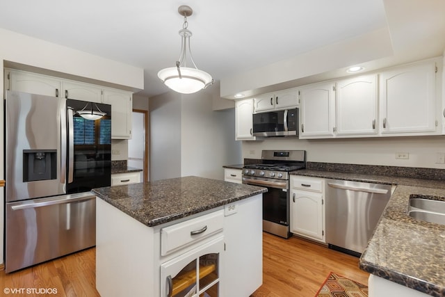 10809 Chaucer Dr, Willow Springs, IL 60480 - kitchen with appliances with stainless steel finishes, light wood finished floors, white cabinets, hanging light fixtures, and a center island