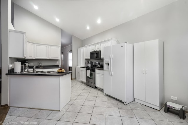 20739 N Weiland Rd, Prairie View, IL 60069 - kitchen featuring gas stove, black microwave, white fridge with ice dispenser, dark countertops, and high vaulted ceiling